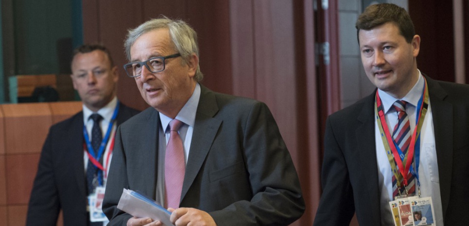 EU Commission President Jean Claude Juncker (C) arrives with his Chief of Cabinet Martin Selmayr (R) prior to a round table session on the second day of a European Union and the Community of Latin America and Caribbean states (EU-CELAC) summit on June 11, 2015 at the European Union headquarters in Brussels. AFP PHOTO/JOHN THYS